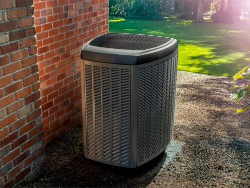 Heat pump sitting next to a home.