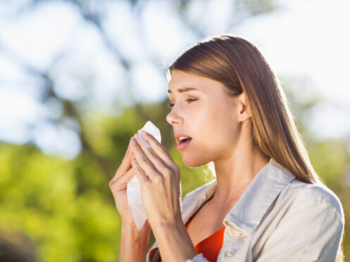 Woman sneezing allergy symptoms