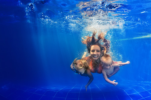 mother and two babies under water